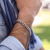Men's curb chain bracelet crafted from 925 sterling silver and fastened with a convenient clasp. 